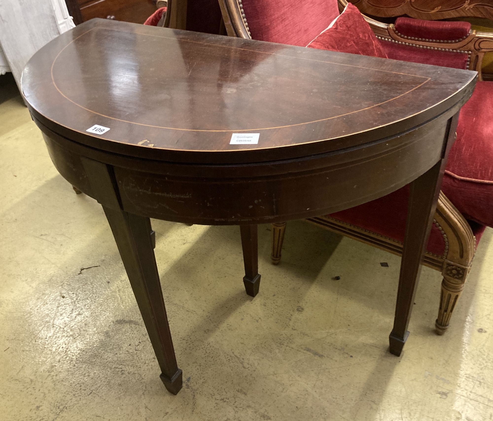 A George III style inlaid mahogany D shaped folding card table, width 92cm, depth 46cm, height 76cm